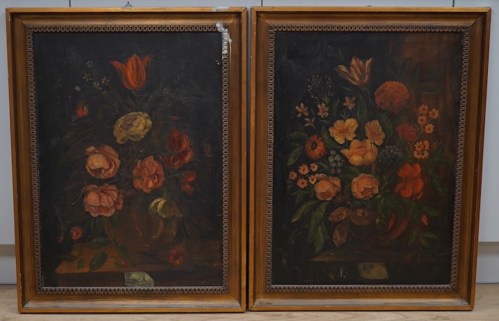 Early 20th century School, pair of oils on canvas, Still lifes of flowers, unsigned, 69 x 49cm. Condition - poor to fair